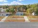 An aerial view of a blue, single-story home nestled among trees at 3779 Sw 147Th Lane Rd, Ocala, FL 34473