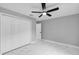 Bedroom featuring tile flooring, a ceiling fan, and closet space at 4250 Se 131St Ln, Belleview, FL 34420