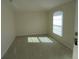 Empty bedroom with neutral walls, carpeting, and window with blinds at 4725 Sw 100Th St, Ocala, FL 34476