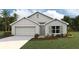 Charming single-story home with a two-car garage and landscaped front yard at 5171 Sw 161St Place Rd, Ocala, FL 34473