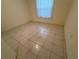 Bedroom with tiled flooring and window with sheer curtains at 8018 Sw 115Th Loop, Ocala, FL 34481