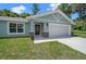 Front view of a light blue house with stone accents, a front door, and garage at 8436 Sw 136Th Ter, Dunnellon, FL 34432