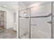 Modern walk-in shower with frameless glass door, tile surround, and built-in bench at 8847 Sw 104Th Cir, Ocala, FL 34481