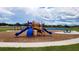 Community playground with slides, climbing features, and a picnic table at 9989 Se 161St Lane Rd, Summerfield, FL 34491