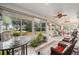 Relaxing sunroom featuring wicker furniture, tiled floors, and ample natural light at 12081 Se 91St Ave, Summerfield, FL 34491