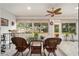 Bright sunroom with wicker furniture and tiled floor, offering tranquil views at 12081 Se 91St Ave, Summerfield, FL 34491