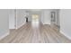 Living room with wood-style flooring and white walls, showing doorways to adjacent rooms at 15458 Sw 10Th Pl, Ocala, FL 34481