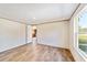 Bedroom with wood-look floors and view of backyard at 18478 Se 58Th Pl, Ocklawaha, FL 32179