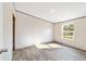 Sunny bedroom with wood-look floors and adjacent closet at 18478 Se 58Th Pl, Ocklawaha, FL 32179