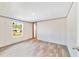 Bright bedroom with wood-look floors and access to hallway at 18478 Se 58Th Pl, Ocklawaha, FL 32179