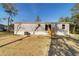 Single-wide manufactured home with wooden steps and AC unit at 18478 Se 58Th Pl, Ocklawaha, FL 32179
