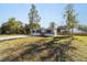 Gray manufactured home with a grassy yard and a long concrete driveway at 18478 Se 58Th Pl, Ocklawaha, FL 32179