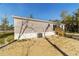 Gray manufactured home with wooden steps and AC unit at 18478 Se 58Th Pl, Ocklawaha, FL 32179