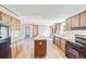 Open concept kitchen with island and stainless steel appliances at 18478 Se 58Th Pl, Ocklawaha, FL 32179