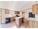 Modern kitchen with island, stainless steel appliances, and wood cabinets at 18478 Se 58Th Pl, Ocklawaha, FL 32179