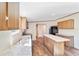Modern kitchen features wood cabinets, an island, and stainless steel appliances at 18478 Se 58Th Pl, Ocklawaha, FL 32179