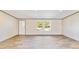 Living room with wood-look floors and two windows at 18478 Se 58Th Pl, Ocklawaha, FL 32179