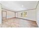 Living room with wood-look floors and large window at 18478 Se 58Th Pl, Ocklawaha, FL 32179