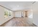 Open living area with wood-look vinyl flooring and large windows at 18478 Se 58Th Pl, Ocklawaha, FL 32179