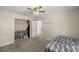 Spacious bedroom with large closet, ceiling fan, and carpeted floors at 213 W Lady Lake Blvd, Lady Lake, FL 32159