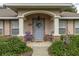 Welcoming front porch with a light blue door, charming rocking chairs, and decorative elements at 213 W Lady Lake Blvd, Lady Lake, FL 32159