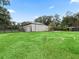Tan metal barn with a separate shed and large yard at 3505 Ne 97Th Street Rd, Anthony, FL 32617