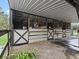 Covered horse stalls with fans and concrete flooring at 3505 Ne 97Th Street Rd, Anthony, FL 32617