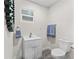 Simple and updated half bathroom with white vanity and gray flooring at 3505 Ne 97Th Street Rd, Anthony, FL 32617