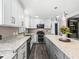 Modern kitchen with granite countertops, stainless steel appliances, and gray shaker cabinets at 3505 Ne 97Th Street Rd, Anthony, FL 32617