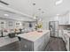 Open concept kitchen features granite island, stainless steel appliances, and view to living room at 3505 Ne 97Th Street Rd, Anthony, FL 32617