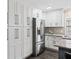 Modern kitchen with white cabinets and stainless steel appliances at 3505 Ne 97Th Street Rd, Anthony, FL 32617
