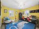 Home office with yellow walls, blue rug, and built-in workspace at 3505 Ne 97Th Street Rd, Anthony, FL 32617