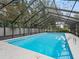 Inviting screened pool with a view of the surrounding landscape at 3505 Ne 97Th Street Rd, Anthony, FL 32617