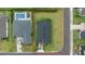 Aerial view of a home with a dark roof, pool, and large backyard at 3810 Se 4Th Ter, Ocala, FL 34480