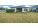 Spacious backyard with a covered patio and lush green lawn at 3810 Se 4Th Ter, Ocala, FL 34480