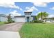 Front exterior of a two-story home with a teal front door and paver driveway at 3810 Se 4Th Ter, Ocala, FL 34480