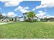 Front yard of a house with a palm tree, green lawn, and paver driveway at 3810 Se 4Th Ter, Ocala, FL 34480