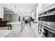 Modern kitchen featuring stainless steel appliances, white cabinets, and an island with seating at 3810 Se 4Th Ter, Ocala, FL 34480