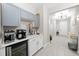 Coffee bar area with gray and white cabinets, beverage cooler, and coffee maker at 3810 Se 4Th Ter, Ocala, FL 34480