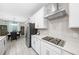 Contemporary kitchen with white cabinets, stainless steel appliances, and a dining area at 3810 Se 4Th Ter, Ocala, FL 34480