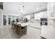 Modern kitchen with white cabinets, large island, and stainless steel appliances at 3810 Se 4Th Ter, Ocala, FL 34480