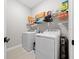 Laundry room with washer, dryer, and overhead storage at 3810 Se 4Th Ter, Ocala, FL 34480