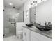 Modern bathroom with double vanity and walk-in shower at 39926 Parkinsonia St, Lady Lake, FL 32159