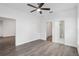 Spacious bedroom with ceiling fan and access to bathroom and closet at 39926 Parkinsonia St, Lady Lake, FL 32159