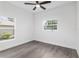 Well-lit bedroom featuring wood-look floors and a window at 39926 Parkinsonia St, Lady Lake, FL 32159
