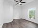 Bright bedroom with ceiling fan and wood-look floors at 39926 Parkinsonia St, Lady Lake, FL 32159