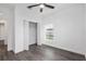 Bedroom with ceiling fan, wood-look floors, and a large closet at 39926 Parkinsonia St, Lady Lake, FL 32159