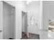 Entryway with coat closet and view of kitchen and front door at 39926 Parkinsonia St, Lady Lake, FL 32159