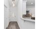 Clean entryway with gray hardwood floor, white walls, and kitchen peek at 39926 Parkinsonia St, Lady Lake, FL 32159