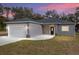 Gray house with white garage door and black front door, newly built at 39926 Parkinsonia St, Lady Lake, FL 32159